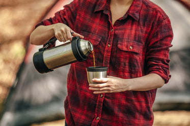 coffee being poured in front of tent