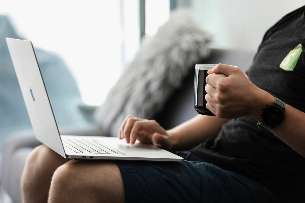 coffee in hand working on the couch close up