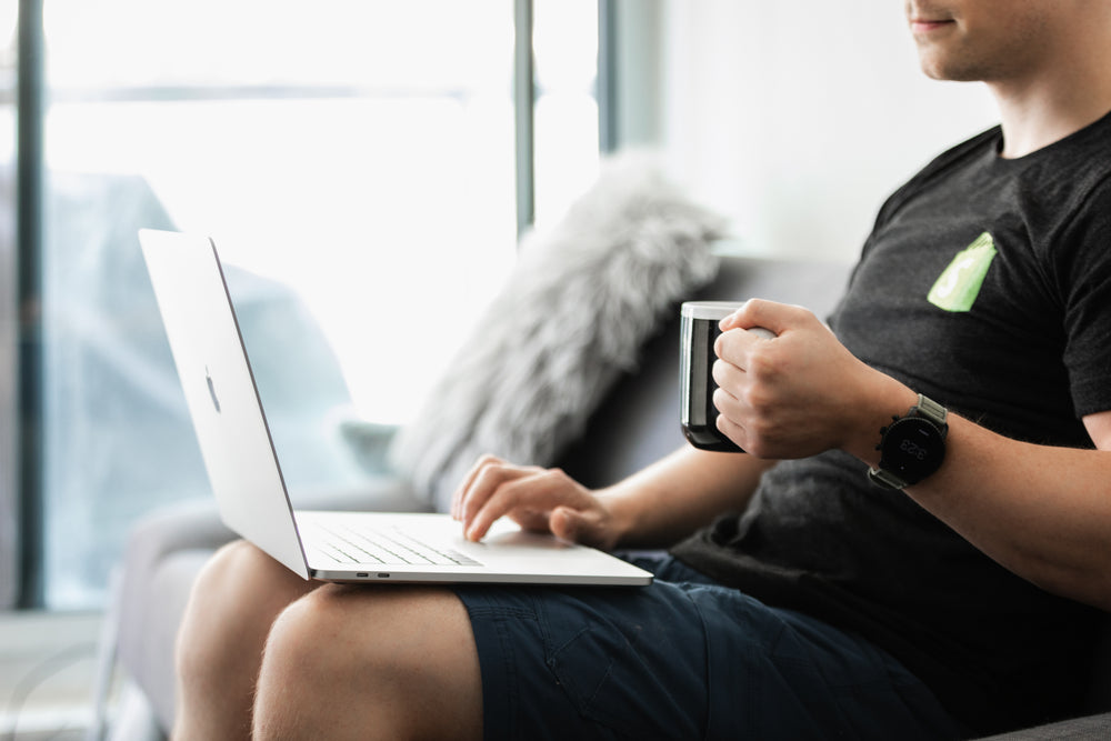 coffee in hands working on the couch