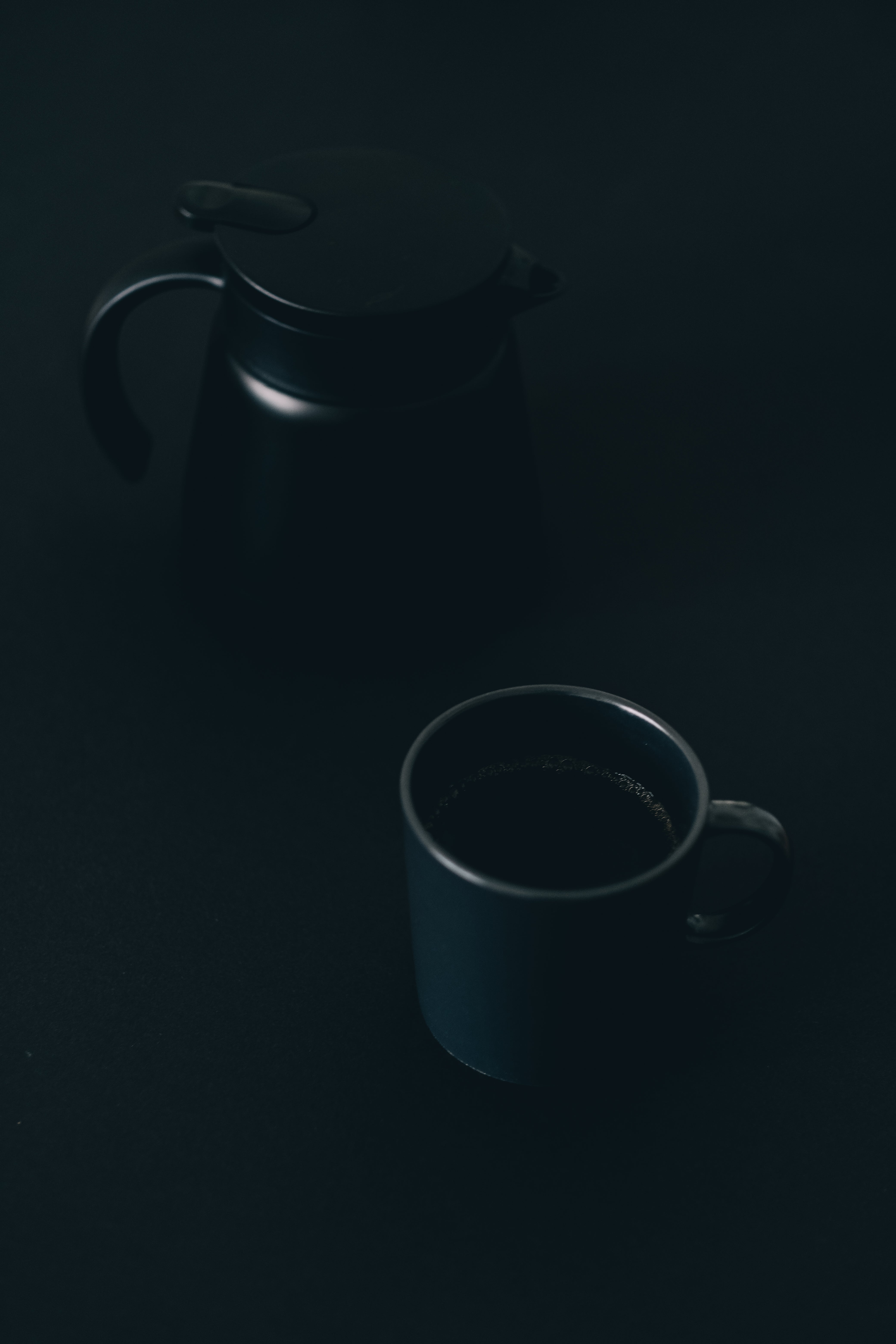 Royalty-Free photo: Black DSLR camera capturing black ceramic mug with  gold-colored spoon