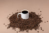 coffee mug in bean pile