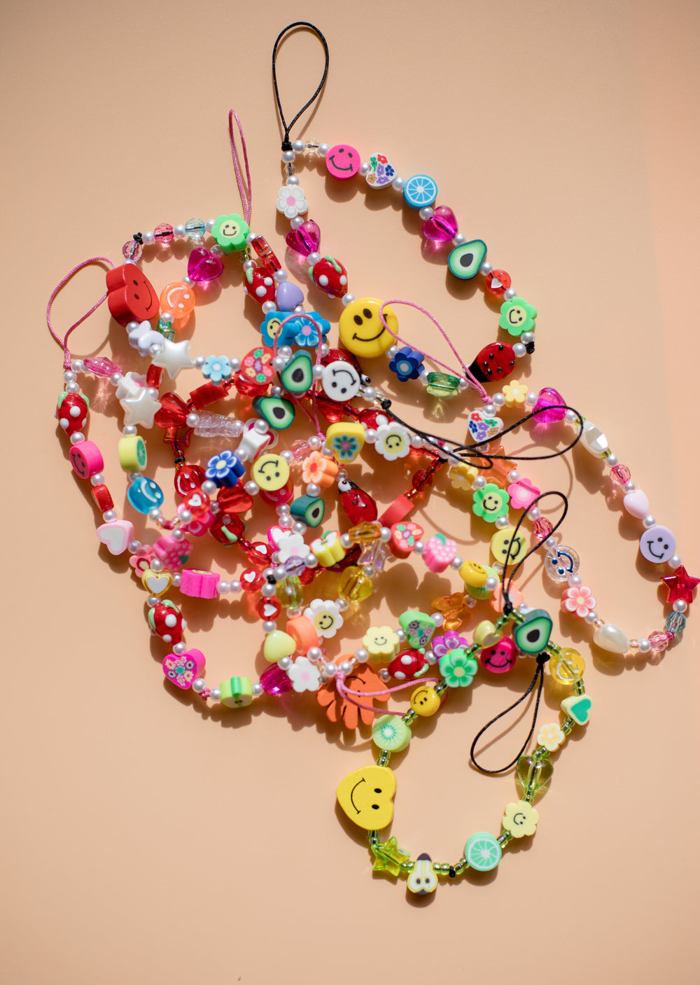 colorful beaded bracelets on a beige background