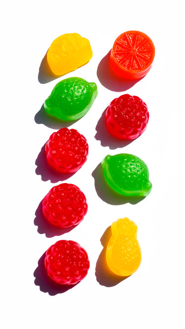 colorful candy in two rows on a white surface