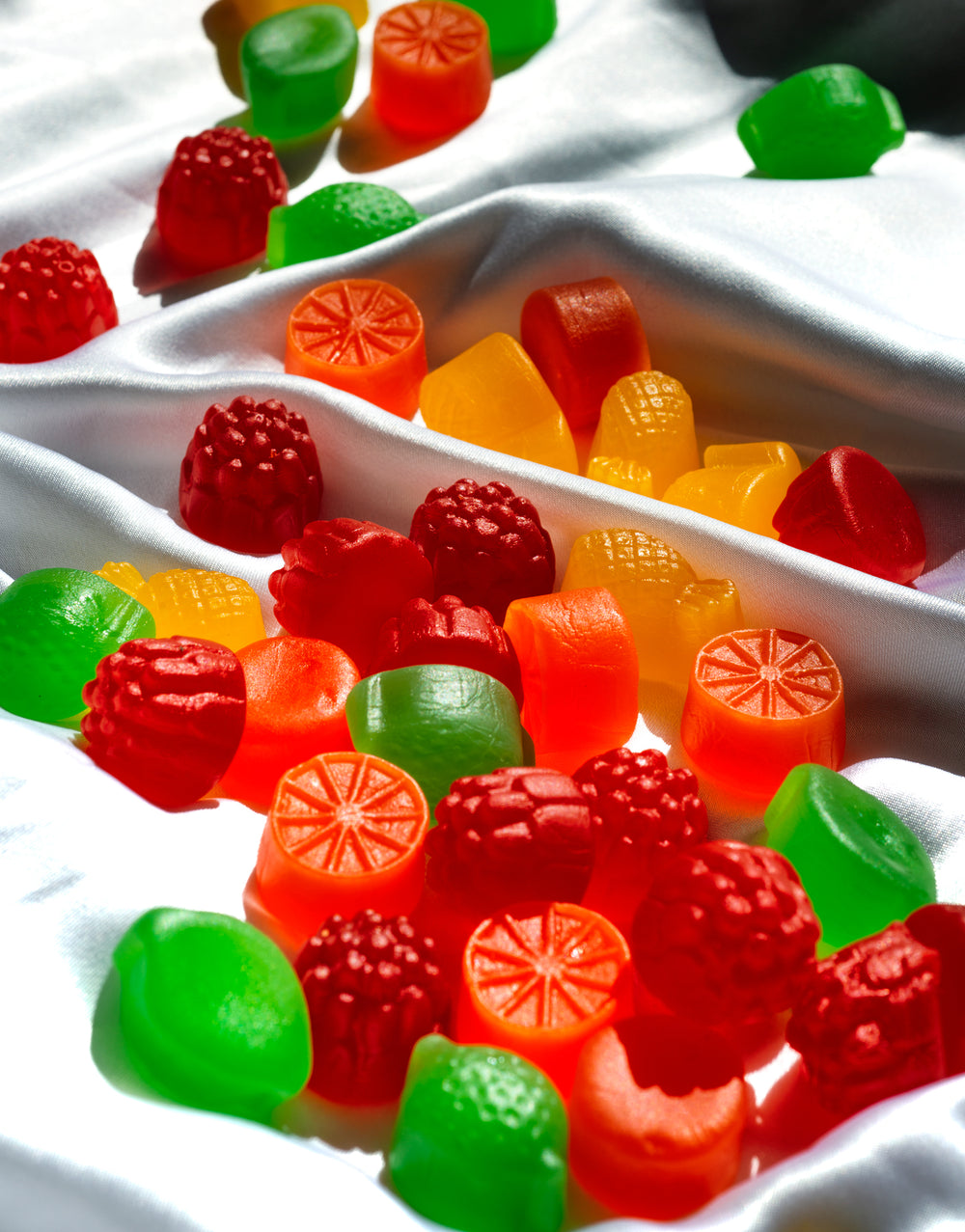colorful candy on white silk fabric