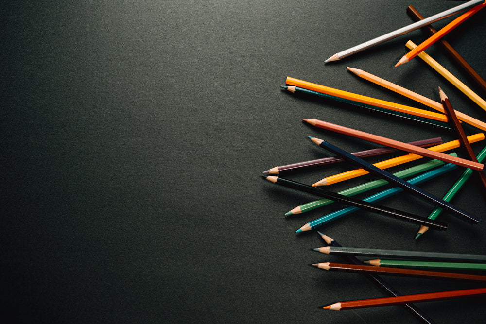 colorful pencil crayons on black background
