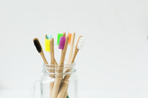 colorful toothbrushes in jar