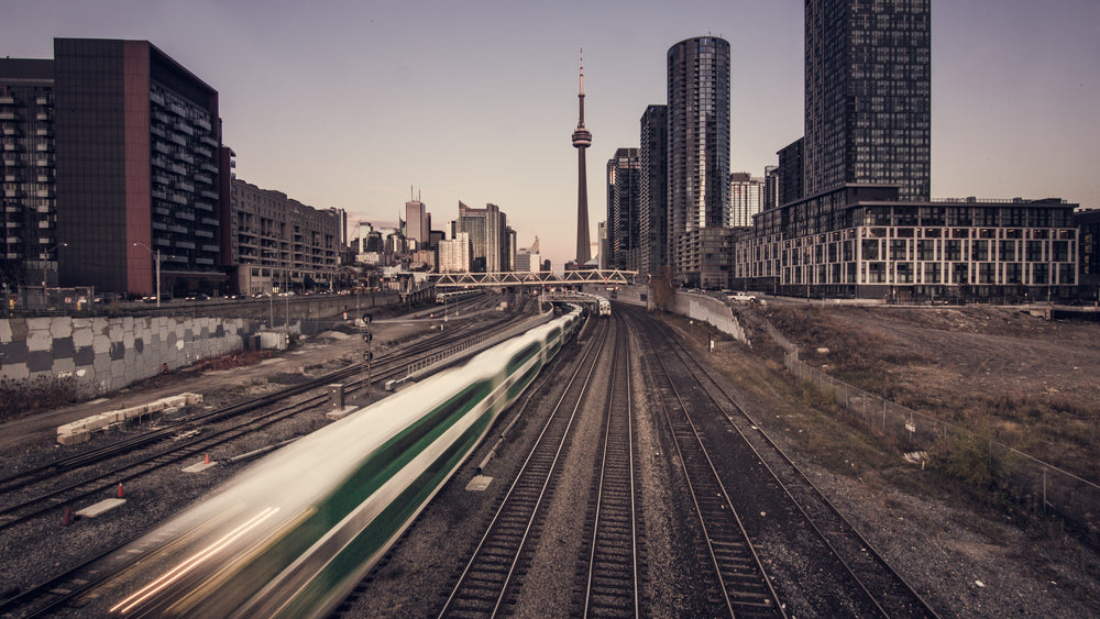 commuter train speeds past in city