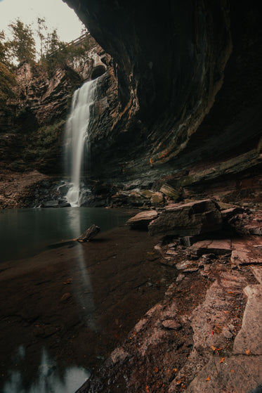 concaved rock face by waterfall