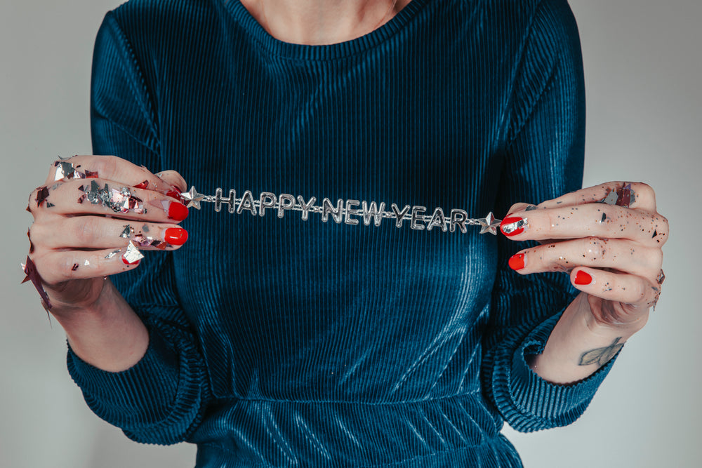 confetti hands holding new year message