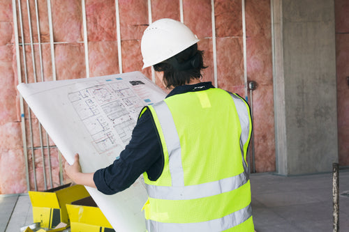 construction worker holding blueprints