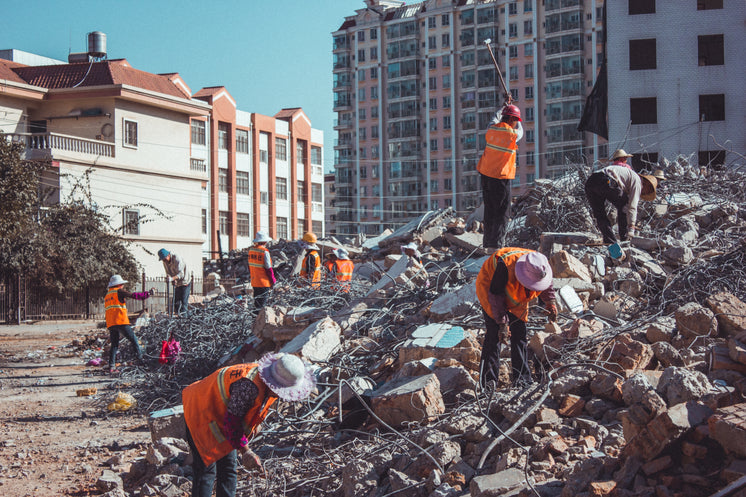 Contruction Workers On Demolished Building