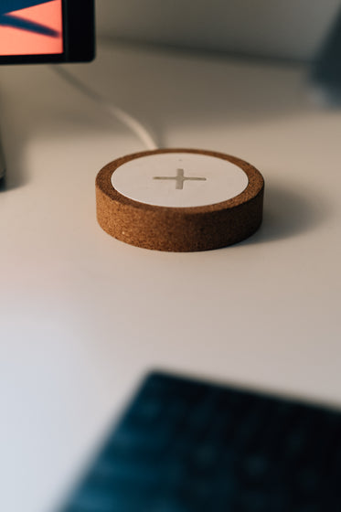 cork wireless charger with white sits on a table