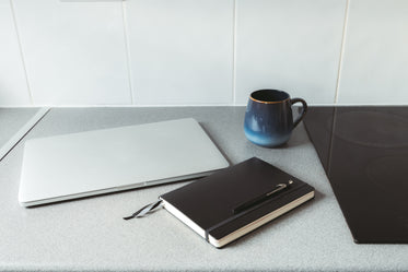 countertop with home office items and mug