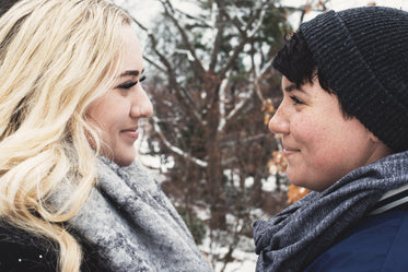 couple face each other and smile