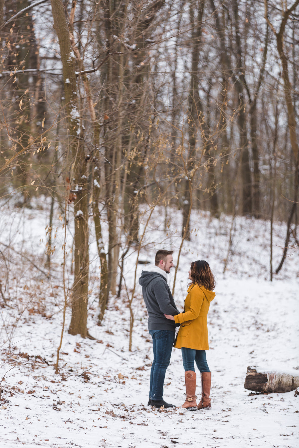 couple holds each other on a stroll in the snow