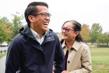 couple laugh in a local park