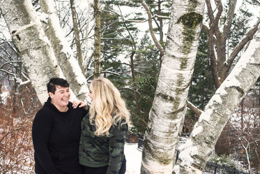 couple laugh together in the snow
