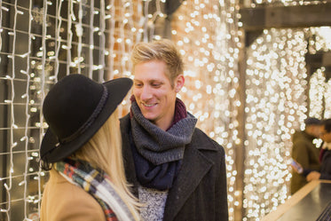 couple locks eyes under lights