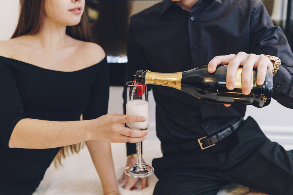 couple pouring champagne