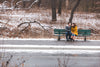 couple shares a smile on a bench by a frosty road