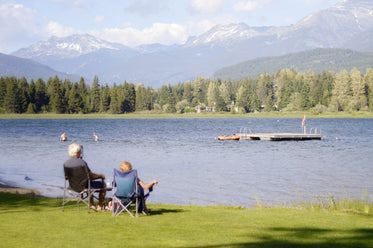 couple sit by the lake and enjoy the view