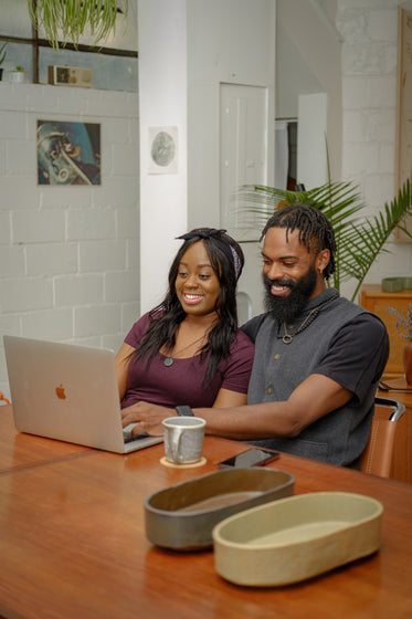 couple sit close together at dining table