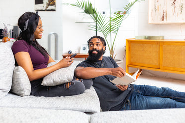 couple sits relaxing in living room