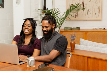 couple sits together shopping online