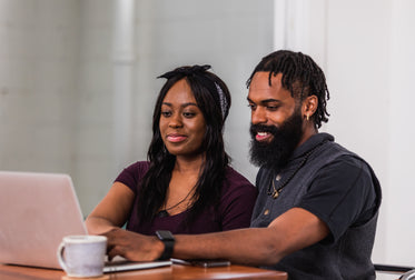 couple smiling while online shopping