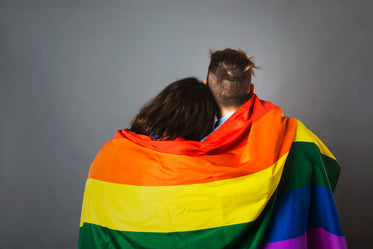 couple wrapped in pride flag