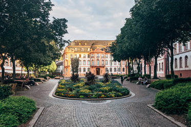 courtyard with a coral and white building at the end