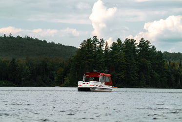 covered boat on lake