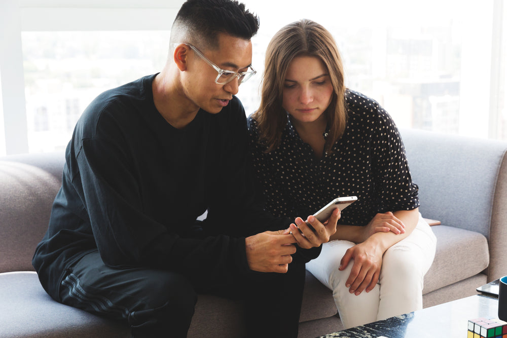 coworkers looking at mobile device