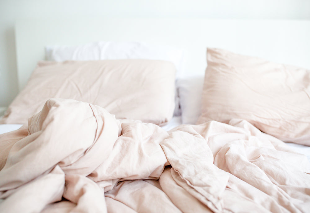 cozy light pink bed scene