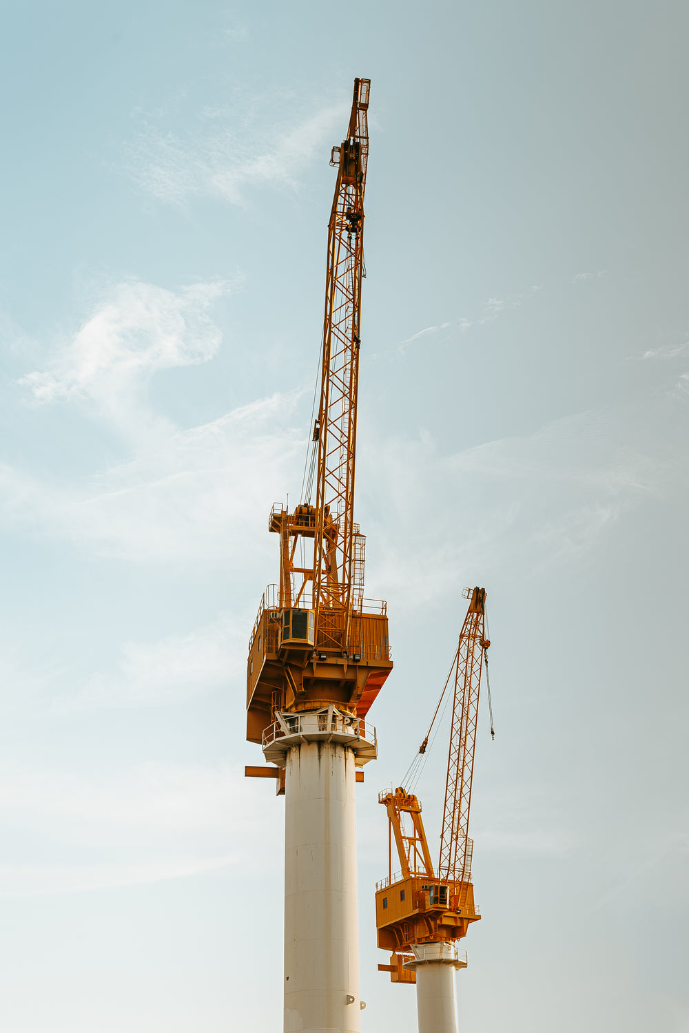 cranes reaching on a clear day