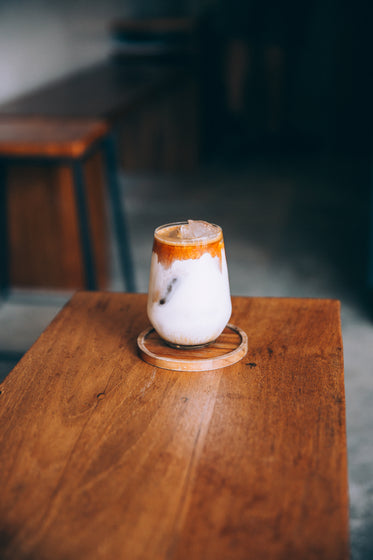 creamy cold drink sits on a wooden table