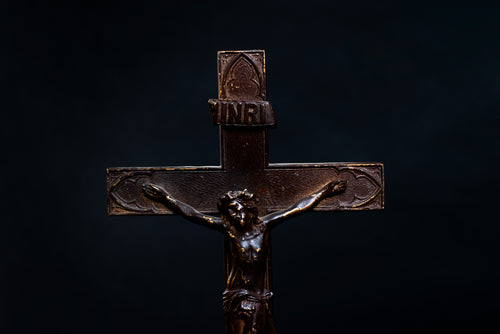 cross with carved figure on black background