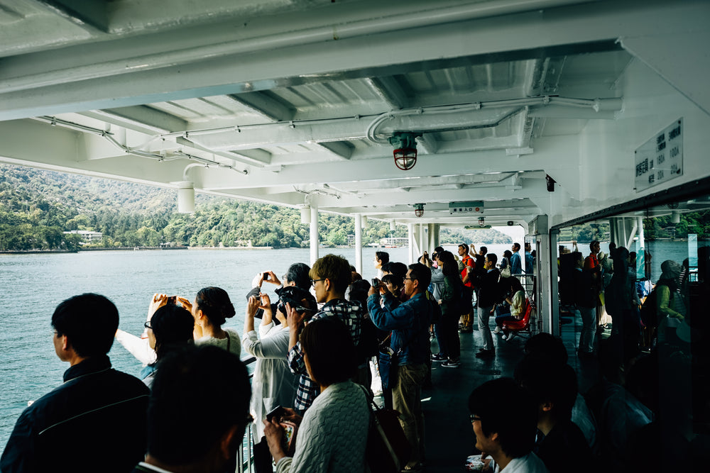 crowd of people taking photos on a boat