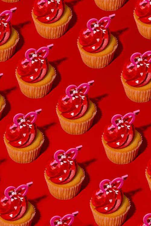 cupcakes in rows against a red background