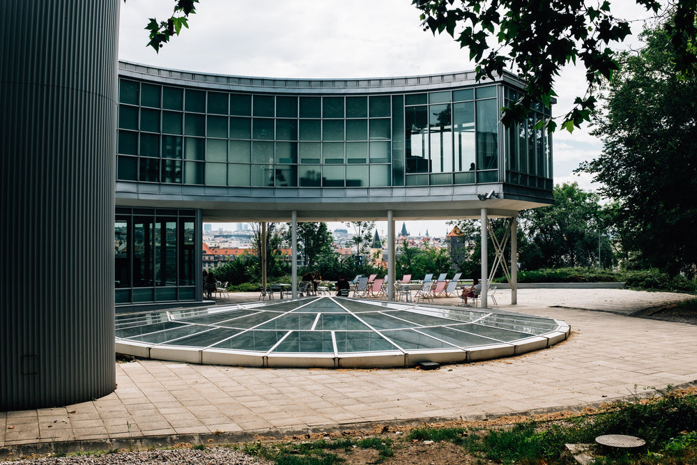 curved glass building on stilts