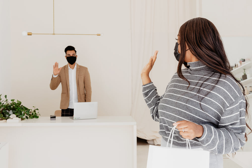 customer and store owner waving goodbye