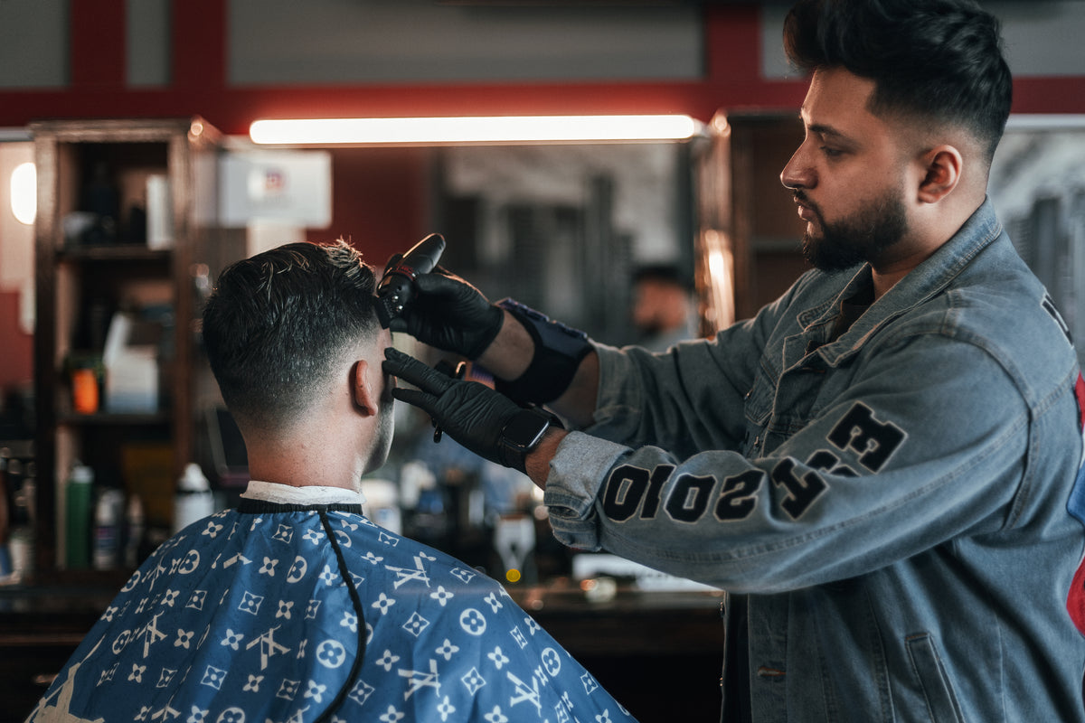 A customer receiving a fade in a barbershop