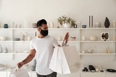 customer leaves store with shopping bags