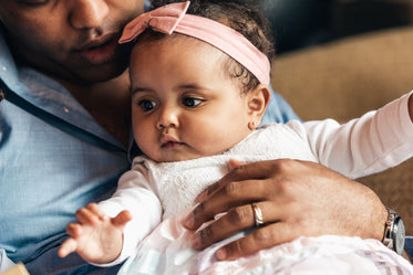 cute baby on her fathers lap