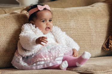 cute happy baby girl on a couch