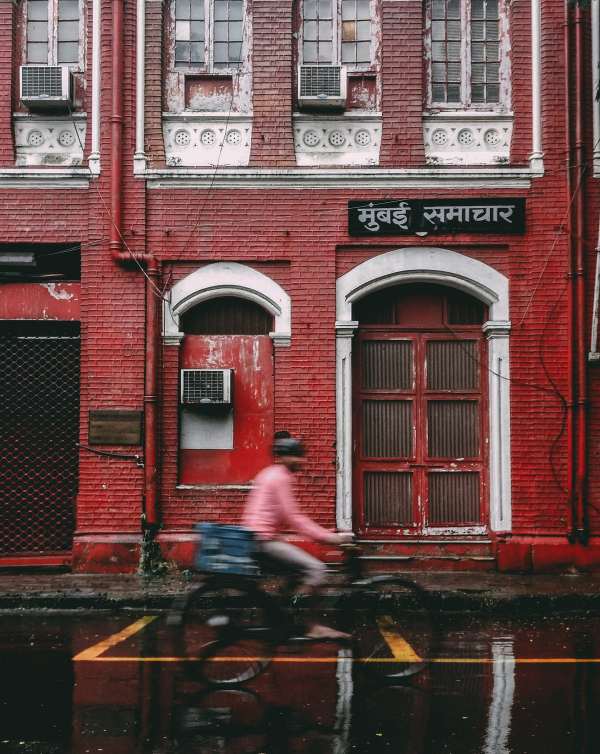 cycling past red building