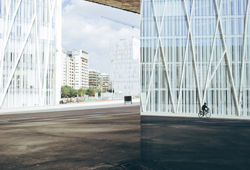 cyclist by modern building