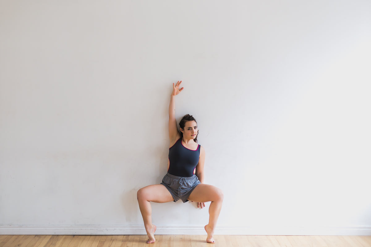dancer poses with arm above head