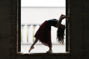 dancer bends back in window