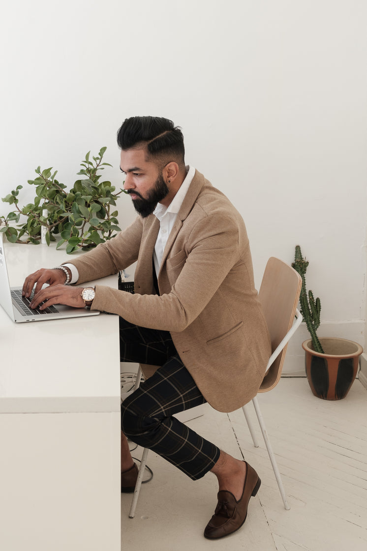 dapper-store-owner-working-on-laptop.jpg